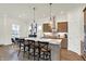 Open kitchen featuring an island with granite countertops, stainless steel appliances, and hardwood floors at 776 Templeton Dr, Carmel, IN 46032