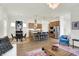 Open living room with island, stainless steel appliances, dining area, hardwood floors and lots of natural light at 776 Templeton Dr, Carmel, IN 46032