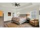 Bright and airy main bedroom with trey ceiling, ceiling fan, area rug and sitting area offers comfort and style at 776 Templeton Dr, Carmel, IN 46032