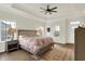 Spacious main bedroom with trey ceiling, ceiling fan, and floral bedding exudes comfort and style at 776 Templeton Dr, Carmel, IN 46032