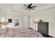 Comfortable main bedroom features tray ceiling, large bed, area rug, and ample natural light at 776 Templeton Dr, Carmel, IN 46032