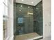 Stylish shower boasts dark green honeycomb tiles and clear glass doors providing a spa-like experience at 776 Templeton Dr, Carmel, IN 46032