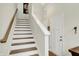 Staircase with painted white risers and wooden treads leads to the upper level at 776 Templeton Dr, Carmel, IN 46032