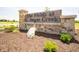 The Fields at Sugar Creek entrance sign with stone detail, landscaping and wood accents at 7877 Magnolia St, New Palestine, IN 46163