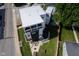 Stunning aerial view of a modern three-story home with a fenced yard, patio, and lush green grass at 806 Shelby St, Indianapolis, IN 46203