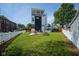 Expansive backyard showcases modern home design, complemented by a well-manicured lawn, patio, and fencing at 806 Shelby St, Indianapolis, IN 46203