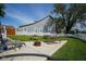 Spacious backyard with a white picket fence, green lawn, patio, and outdoor seating at 806 Shelby St, Indianapolis, IN 46203