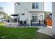View of the home's backyard featuring a deck, stairs, and grassy area at 806 Shelby St, Indianapolis, IN 46203