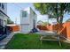 Backyard featuring a picnic table, green grass, gravel, and a wooden fence; perfect for relaxation and outdoor activities at 806 Shelby St, Indianapolis, IN 46203