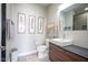 Modern bathroom with vessel sink, sleek vanity, contemporary art and toilet with a plush rug at 806 Shelby St, Indianapolis, IN 46203