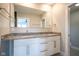 Bathroom featuring double sinks, granite countertops, modern white cabinetry, and a large mirror at 806 Shelby St, Indianapolis, IN 46203