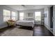 Bright bedroom features hardwood floors, light walls, and ample windows for natural light and cozy seating at 806 Shelby St, Indianapolis, IN 46203