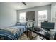 Bedroom featuring a queen bed, dark wood floors, and natural light from the windows at 806 Shelby St, Indianapolis, IN 46203