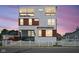 Beautiful three-story home offers modern design with white siding, wood accents, and a picket fence at 806 Shelby St, Indianapolis, IN 46203