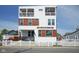 Stylish three-story home boasts modern design with white siding, wood accents, and a charming picket fence at 806 Shelby St, Indianapolis, IN 46203