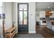 Inviting foyer with a shoe rack, black front door, and a view into the open kitchen area at 806 Shelby St, Indianapolis, IN 46203
