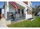Welcoming front porch with American flag, black railing, and inviting entrance enhances the curb appeal of this home at 806 Shelby St, Indianapolis, IN 46203