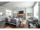 Bright living room featuring modern sofas, a fireplace, a TV, and access to the outdoor patio at 806 Shelby St, Indianapolis, IN 46203