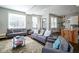 Bright living room with hardwood floors, two sofas, a decorative rug, and large windows at 806 Shelby St, Indianapolis, IN 46203