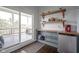 Wet bar near porch with shelving and space for a mini-fridge and a sliding glass door to the patio at 806 Shelby St, Indianapolis, IN 46203