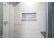 Close up of a stylish shower featuring tile, a built-in niche, and modern fixtures at 806 Shelby St, Indianapolis, IN 46203
