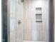 Elegant shower with stylish tile, glass door, and convenient built-in shelving at 806 Shelby St, Indianapolis, IN 46203