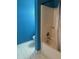 Bathroom features a tile floor, blue walls, bathtub and shower at 8113 Maple Stream Ln, Indianapolis, IN 46217