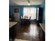 Dining area adjacent to the kitchen with a wooden table, seating for six, and bright blue walls at 8113 Maple Stream Ln, Indianapolis, IN 46217