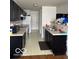 Functional kitchen with black cabinets and essential appliances at 8113 Maple Stream Ln, Indianapolis, IN 46217