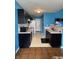 Functional kitchen featuring dark cabinets, white appliances, laminate countertops, and linoleum floors at 8113 Maple Stream Ln, Indianapolis, IN 46217