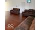 Spacious living room featuring hardwood floors and comfortable leather seating at 8113 Maple Stream Ln, Indianapolis, IN 46217