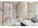 Bathroom with shower-tub combination, floral shower curtain, vanity, sink, and toilet at 8115 Cole Wood Blvd, Indianapolis, IN 46239