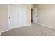 Bedroom featuring closet with sliding doors, neutral walls and carpet, and an open doorway at 8115 Cole Wood Blvd, Indianapolis, IN 46239