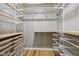 Organized walk-in closet with shelving and wooden floors at 8115 Cole Wood Blvd, Indianapolis, IN 46239