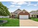 Charming single-Gathering home with a brick facade, well-manicured lawn, and a two-car garage in a suburban neighborhood at 8115 Cole Wood Blvd, Indianapolis, IN 46239