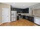 Kitchen with stainless appliances and dark cabinets, plus hardwood floors at 8115 Cole Wood Blvd, Indianapolis, IN 46239