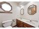 Bathroom featuring double sinks with wood cabinetry and an octagon-shaped window for natural light at 817 S Jefferson St, Brownsburg, IN 46112