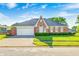 Charming brick home with well-manicured lawn and two-car garage under a bright, sunny sky at 817 S Jefferson St, Brownsburg, IN 46112