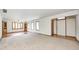 Open living space featuring neutral carpet, white walls, and natural light from many windows at 817 S Jefferson St, Brownsburg, IN 46112