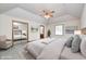 Serene bedroom with plush carpet, ceiling fan, and ensuite bathroom and expansive mirror wardrobe doors at 817 S Jefferson St, Brownsburg, IN 46112