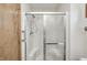 Shower with a glass door, a built-in seat, and a convenient adjustable shower head in the bathroom at 817 S Jefferson St, Brownsburg, IN 46112