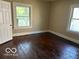 Bright bedroom featuring hardwood floors and natural light from the large windows at 822 W 7Th St, Muncie, IN 47302