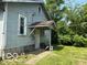 Side view of house with backyard access and showing the unique construction design at 822 W 7Th St, Muncie, IN 47302