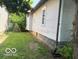 Side view of house with a glimpse of the backyard and its features at 822 W 7Th St, Muncie, IN 47302