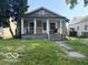 Charming home featuring a welcoming front porch and a classic architectural design at 822 W 7Th St, Muncie, IN 47302