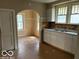 Bright kitchen features with white cabinetry and a stainless steel sink at 822 W 7Th St, Muncie, IN 47302