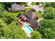 Stunning aerial view of a home with a private pool, deck, hot tub, and lush green landscaping at 8534 Helmsman Cir, Indianapolis, IN 46256