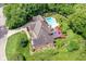 Aerial view of a landscaped home with an in-ground pool, deck, and lush green surroundings at 8534 Helmsman Cir, Indianapolis, IN 46256