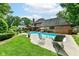 An expansive backyard with a lush lawn, mature trees, and a sparkling in-ground pool at 8534 Helmsman Cir, Indianapolis, IN 46256