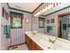 A brightly lit bathroom features a double sink vanity and striped wallpaper at 8534 Helmsman Cir, Indianapolis, IN 46256